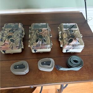 3 Used Meidase Camo Trail Camera Set with Straps for sale.